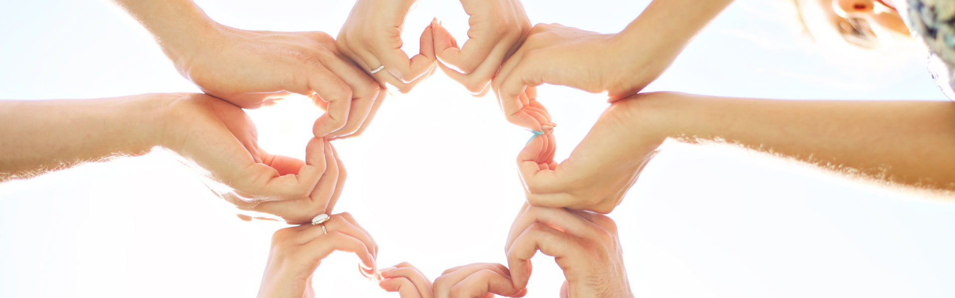 group of hands forming a heart